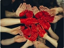 Heart painted on a group of people's hands